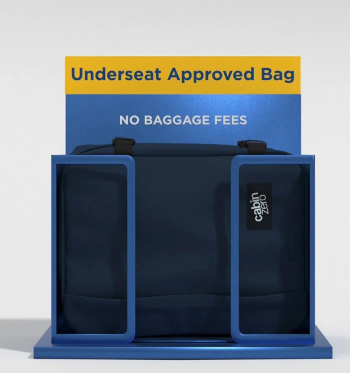 A dark navy blue underseat bag displayed inside a blue plastic frame with a yellow and blue sign behind it reading 'Underseat Approved Bag' and 'NO BAGGAGE FEES'. A small black 'cabin zero' label is visible on the right side of the bag.