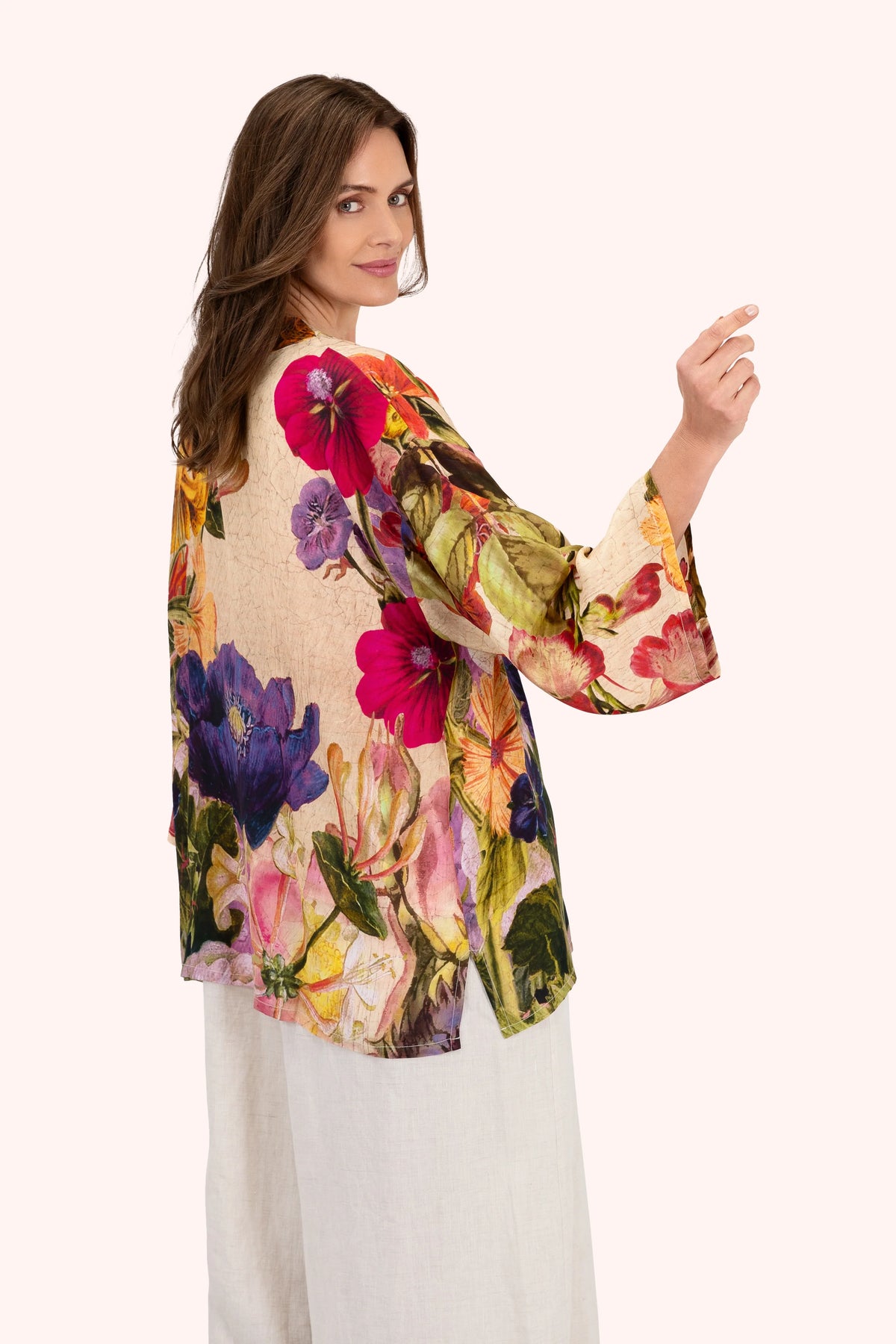 Woman wearing a colorful floral kimono against a white background by Weirs Gifts