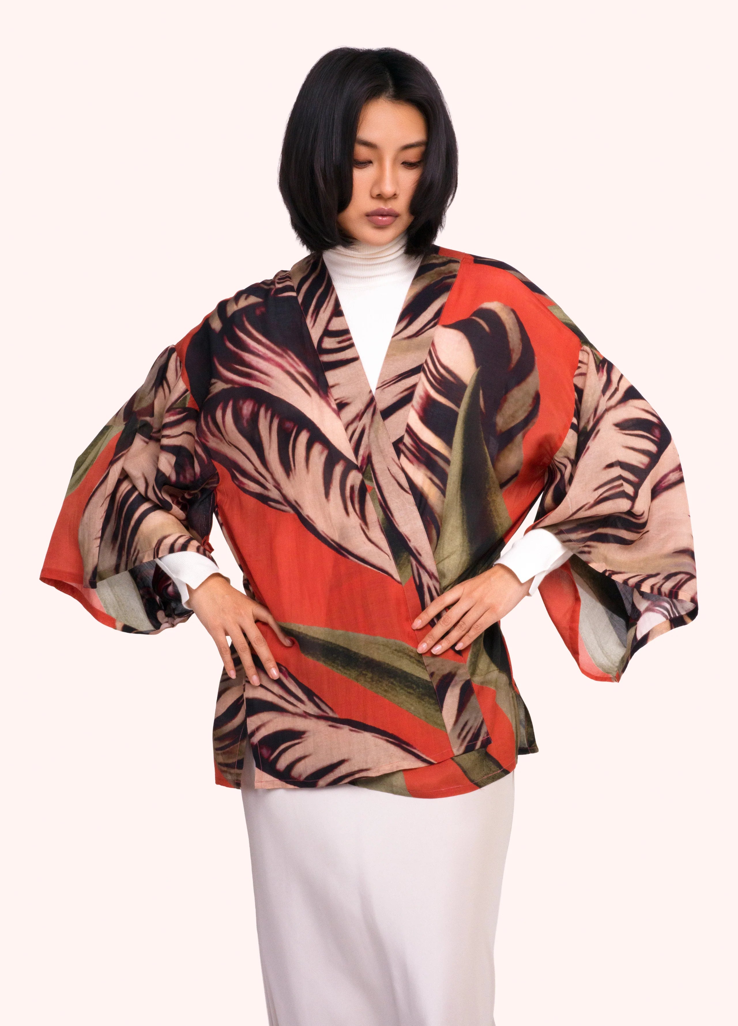 Woman wearing a colorful patterned jacket on a white background by Weirs Gifts