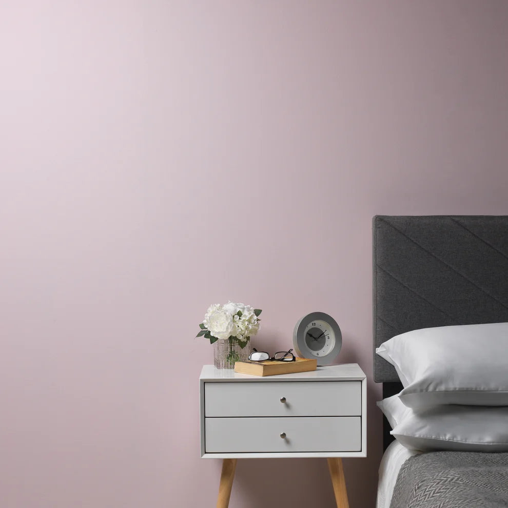 Bedroom wall painted in Frenchic Ballerina with bedside table and grey bed