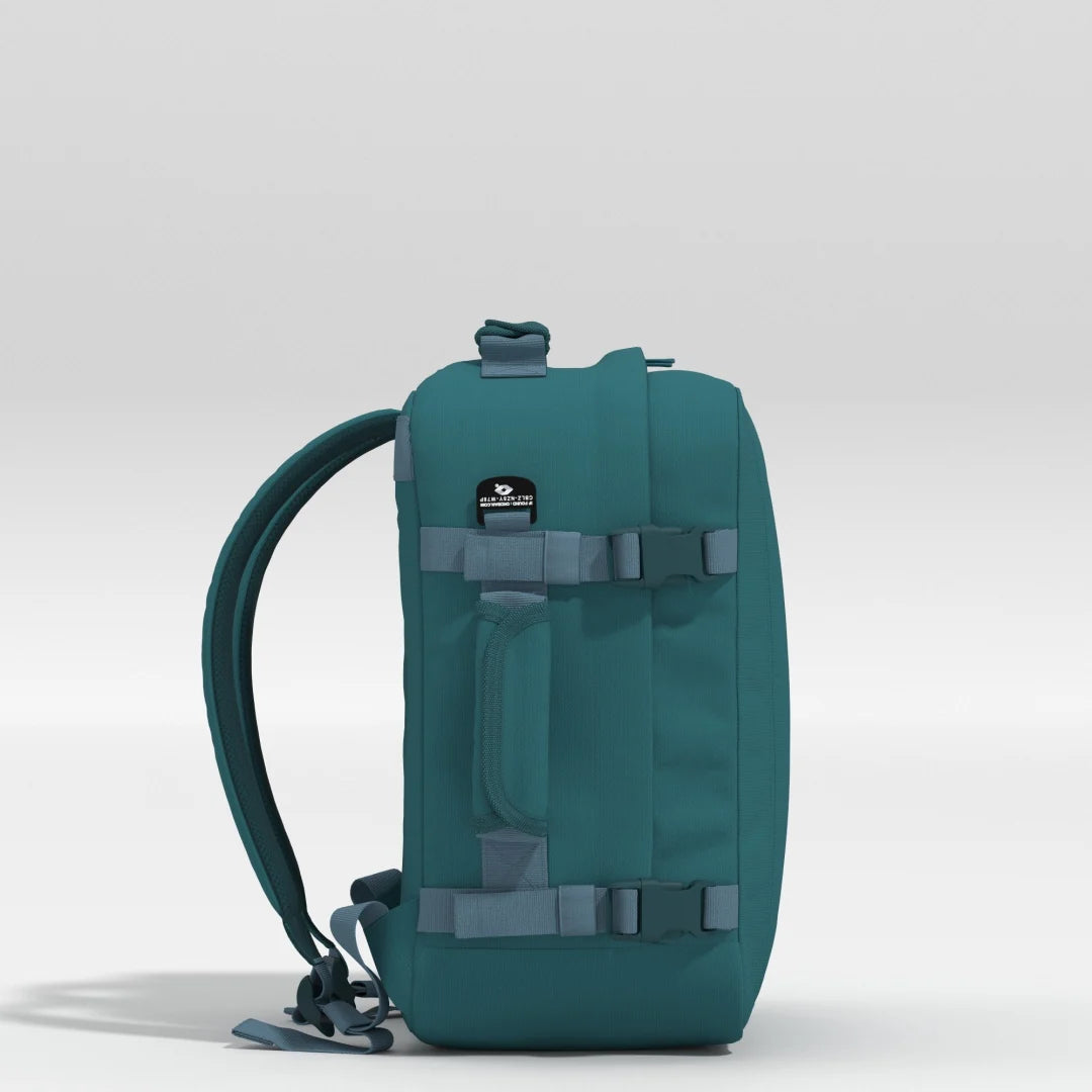 Teal backpack with gray straps on a light gray background