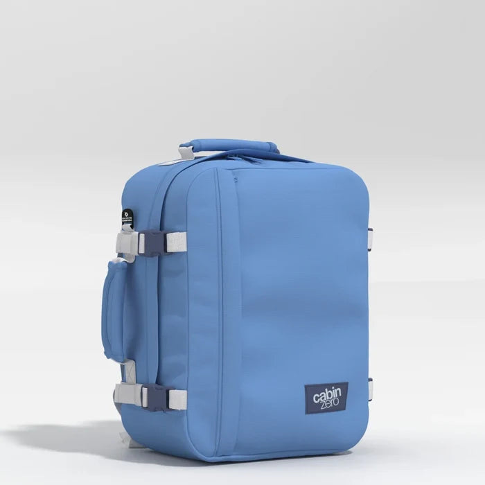 Blue suitcase with 'cabin zero' logo on a light gray background