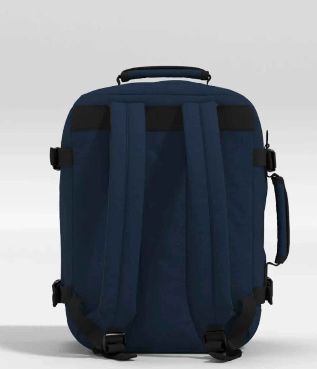 A navy blue rolling backpack shown from the back, featuring padded shoulder straps, a top carry handle, side compression straps, and a telescoping handle, photographed against a neutral light gray background.