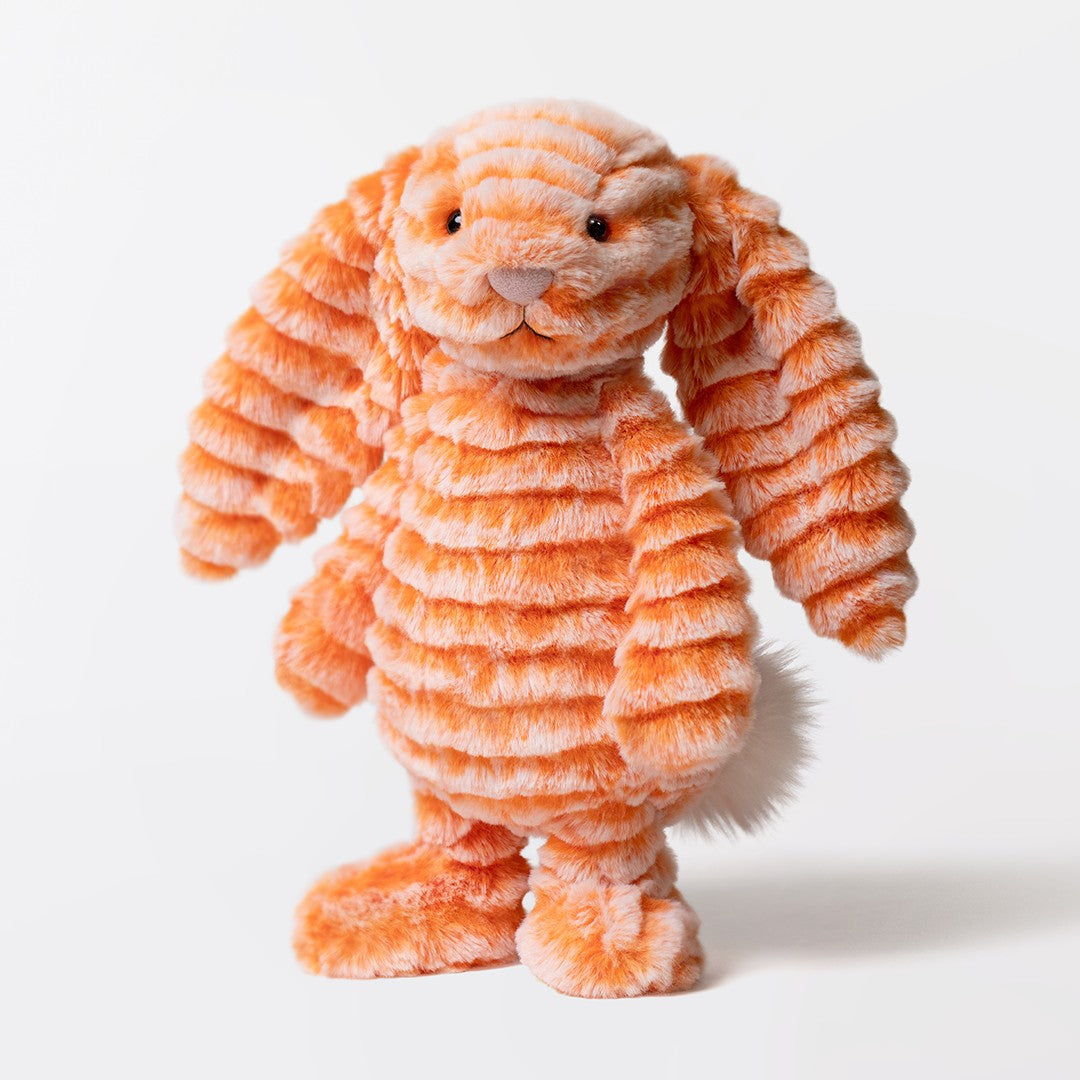 An orange and white striped plush bunny toy with a textured, ribbed fabric and floppy ears, standing against a clean white background at Weirsgifts.ie