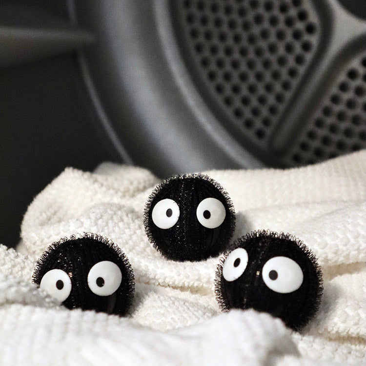 Black Kikkerland Laundry Buddies with eyes resting on a towel