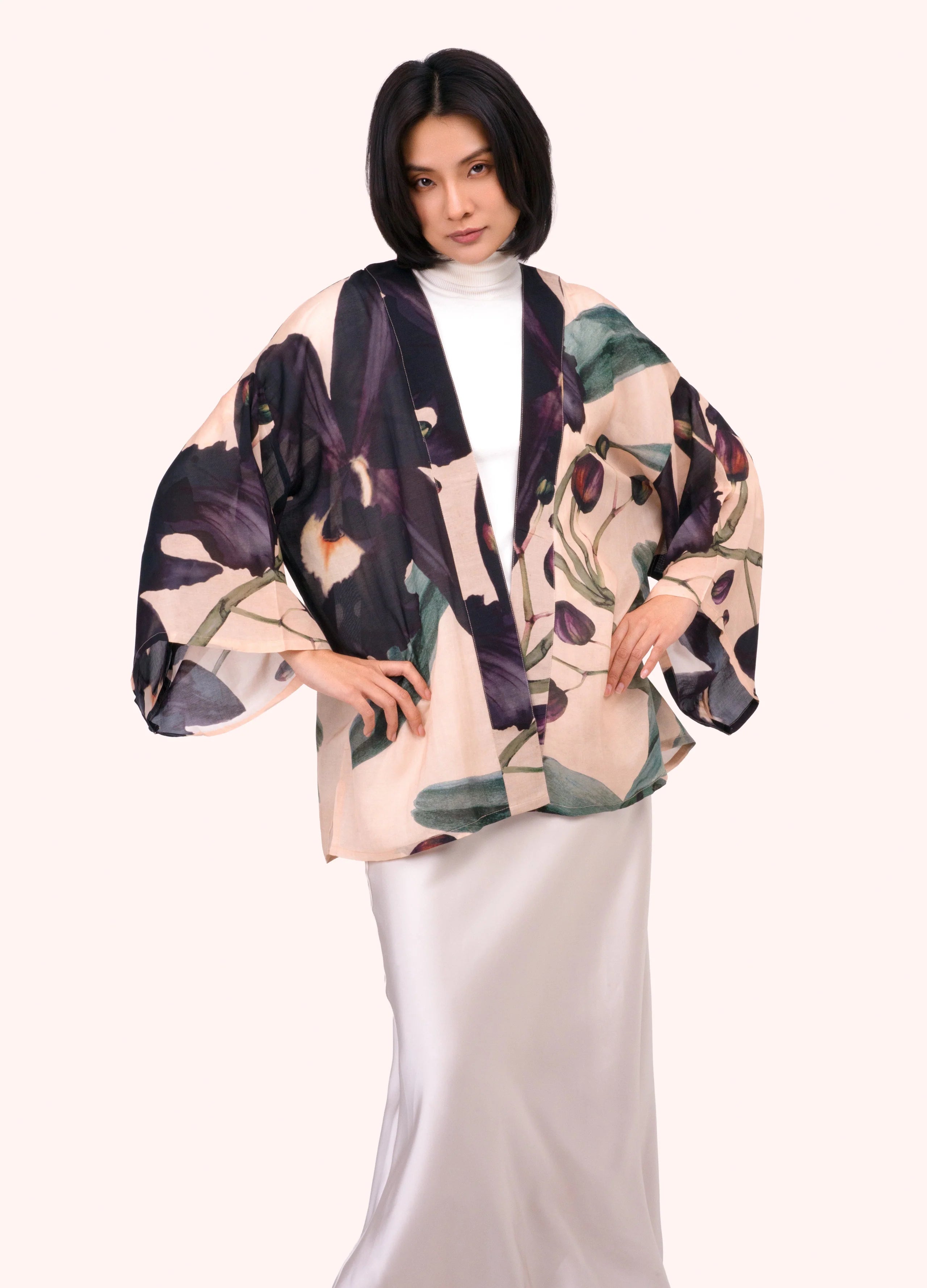 Woman wearing a floral kimono-style top on a white background by Weirs Gifts