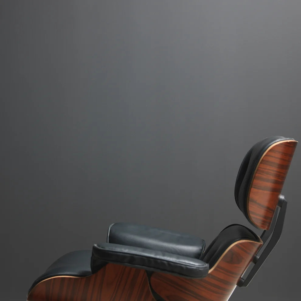 Frenchic Panther off-black wall behind a wood and black upholstered lounge chair