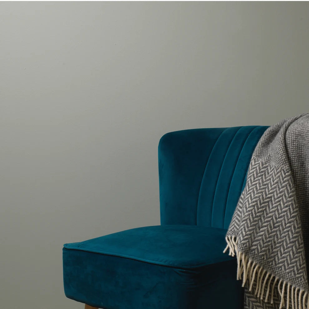 Frenchic Wedgewood Green wall behind a teal chair with a patterned throw