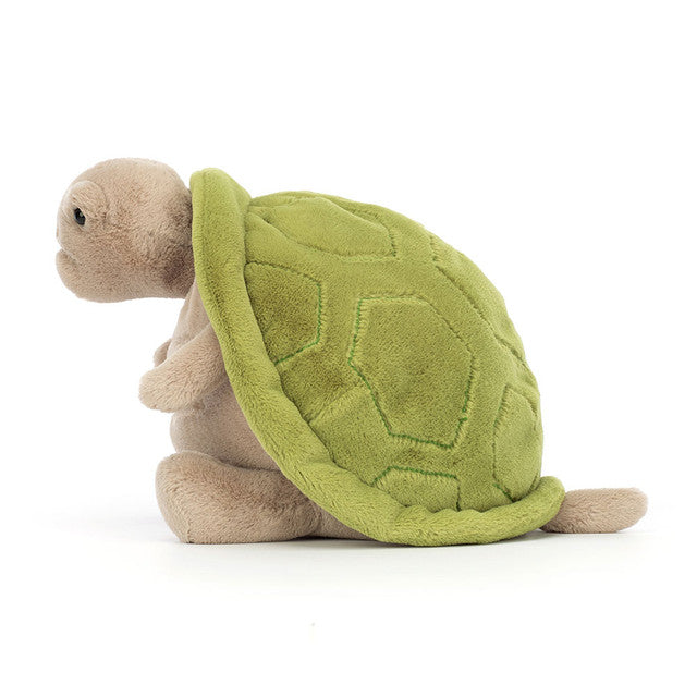 Plush turtle toy with green shell on a white background