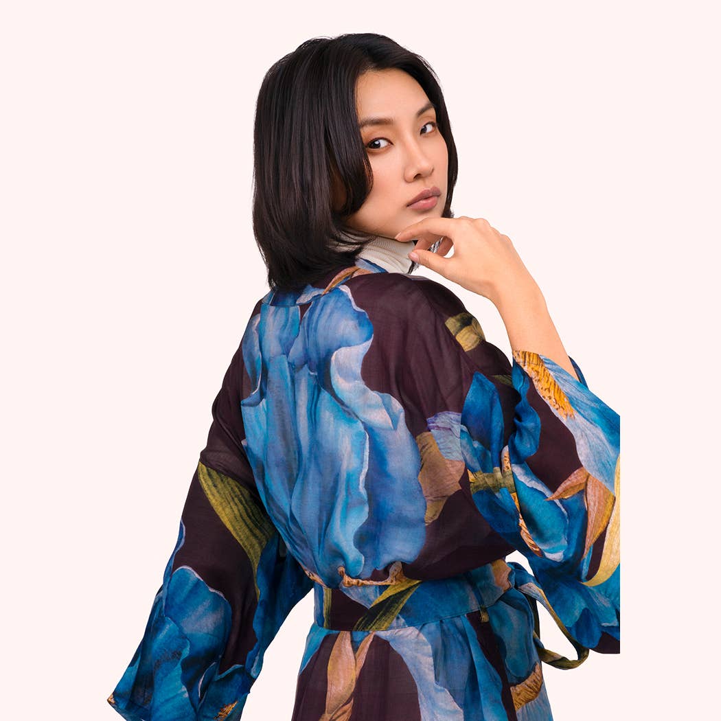 Woman wearing a colorful, abstract-patterned garment on a white background by Weirs Gifts
