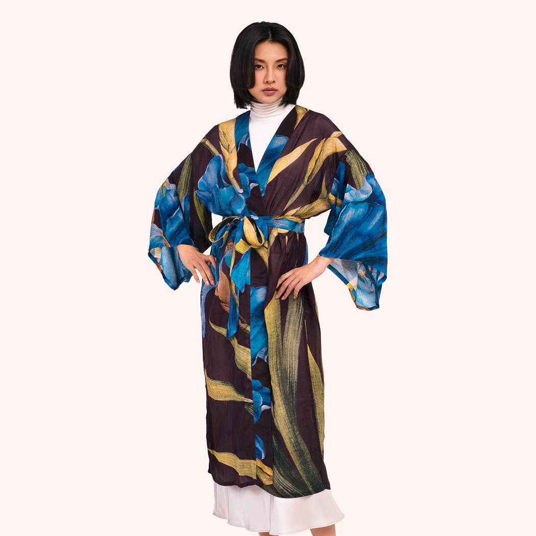 Woman wearing a colorful robe with floral patterns on a white background by Weirs Gifts